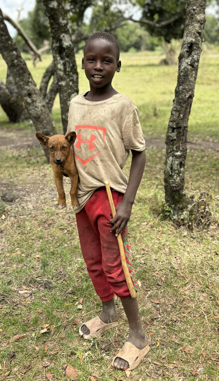 Boy with red pants and puppy