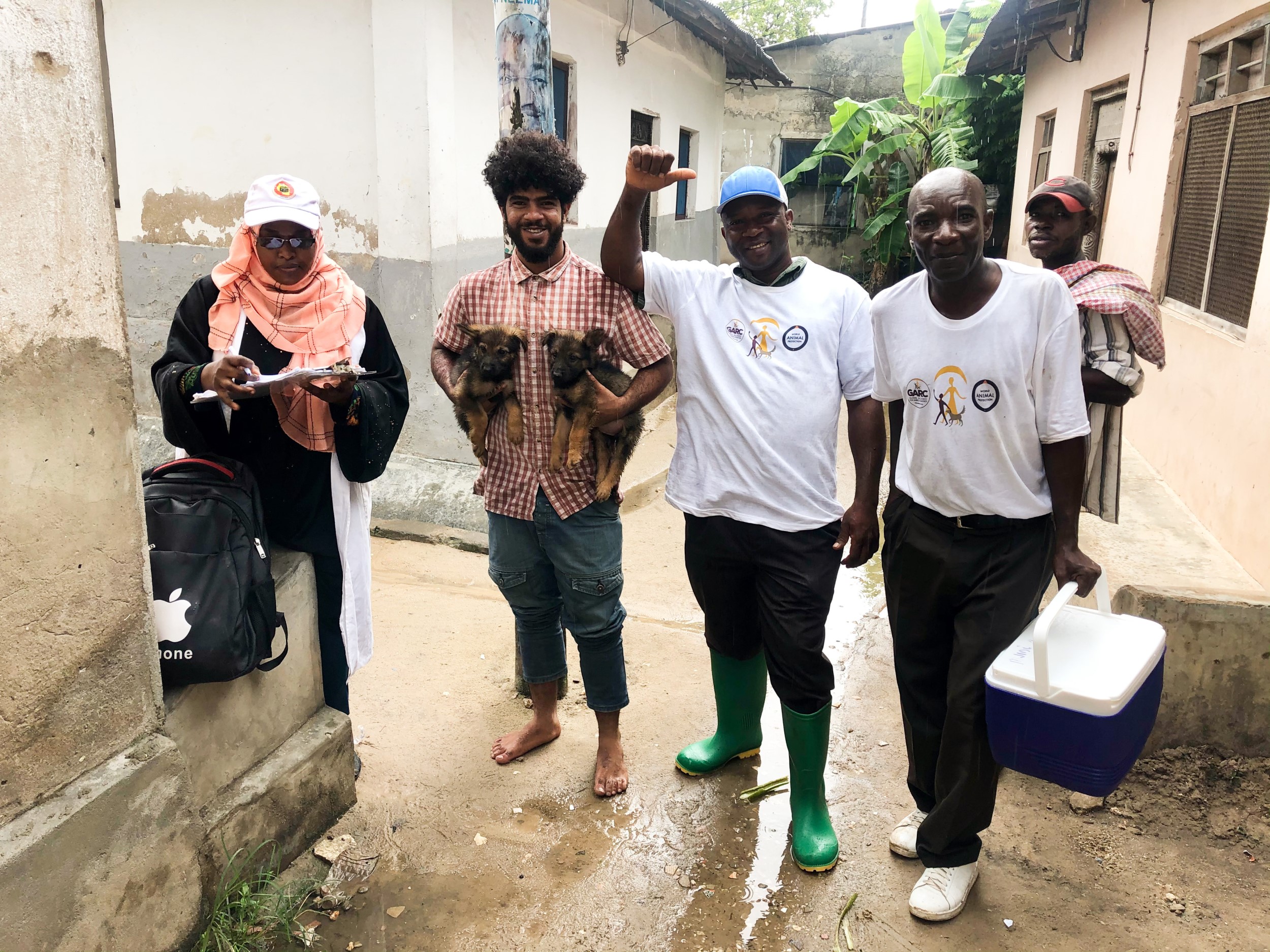 A happy owner celebrates getting his puppies vaccinated against rabies with the GARC project in Zanzibar.